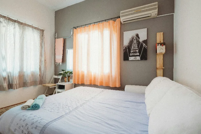 Freshly made bed with clean linen in a short-stay rental