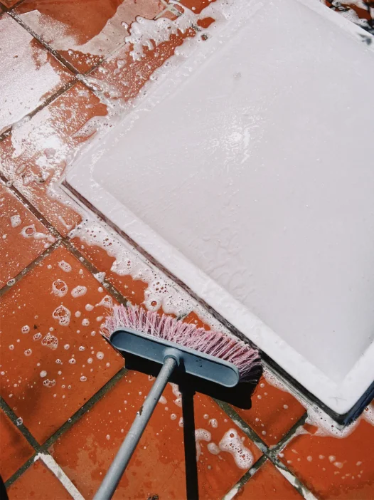 Tiled floor being machine scrubbed