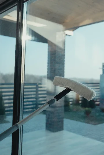 Window glass being cleaned with a squeegee