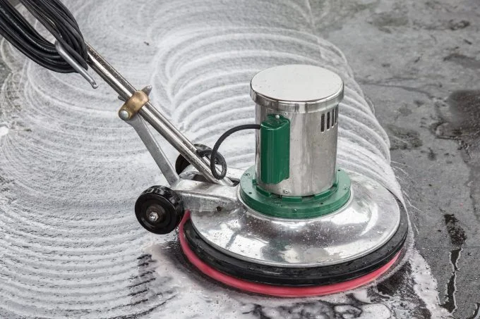 Tiled hard floor being machine scrubbed